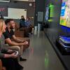 People sitting on couches playing video games