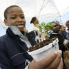 A student with a plant he just potted