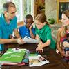 a family sitting around a table reading pamphlets