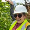 Dr. Mariana Bonfim in a hardhat and vest in the woods