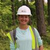 Keri Kern wearing a hardhat in the woods. 