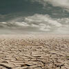 an image of drought ravaged mud flats, the ground is cracked