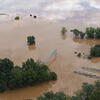 spring flooding, a river flooding its banks everything is covered except for the trees